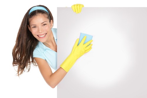 Cleaner preparing a kitchen clean in a SW14 property